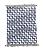A handmade Morrocan Beni Ourain Berber rug with blue and white stepped design.