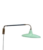 An Italian 1950s Stilnovo brass extendable telescopic wall light with green stitched leather arm