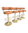 A set of four Börje Johanson “Jupiter” bar stools in cognac faux leather