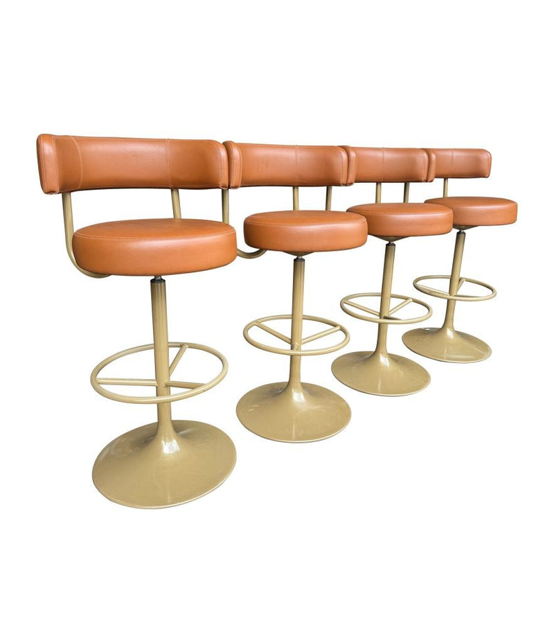 A set of four Börje Johanson “Jupiter” bar stools in cognac faux leather