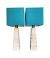 Mid Century table lamps with Travertine bases and brass fittings with blue linen shades