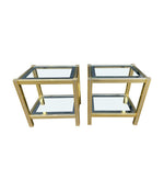 A pair of French 1970s gilt metal side tables by Pierre Vandel with original part mirrored glass shelves