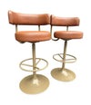 A set of four Börje Johanson “Jupiter” bar stools in cognac faux leather