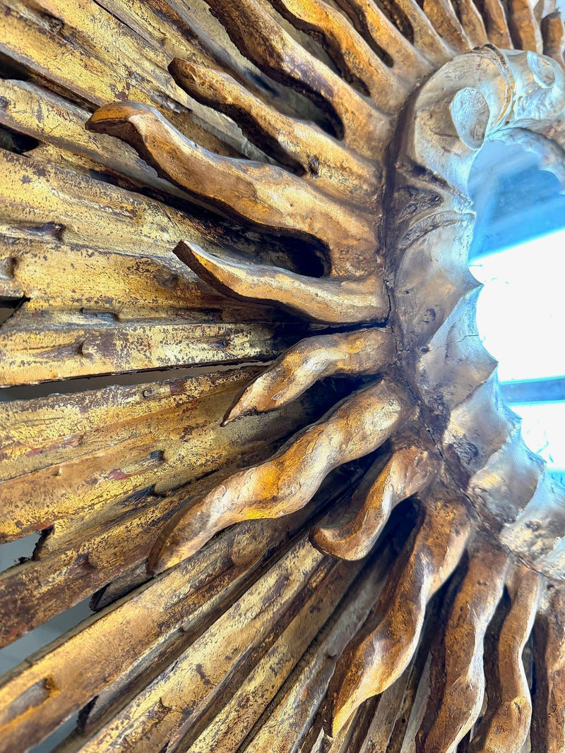 A large 1940s French carved wood gilt sunburst mirror