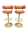 A set of four Börje Johanson “Jupiter” bar stools in cognac faux leather