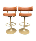 A set of four Börje Johanson “Jupiter” bar stools in cognac faux leather