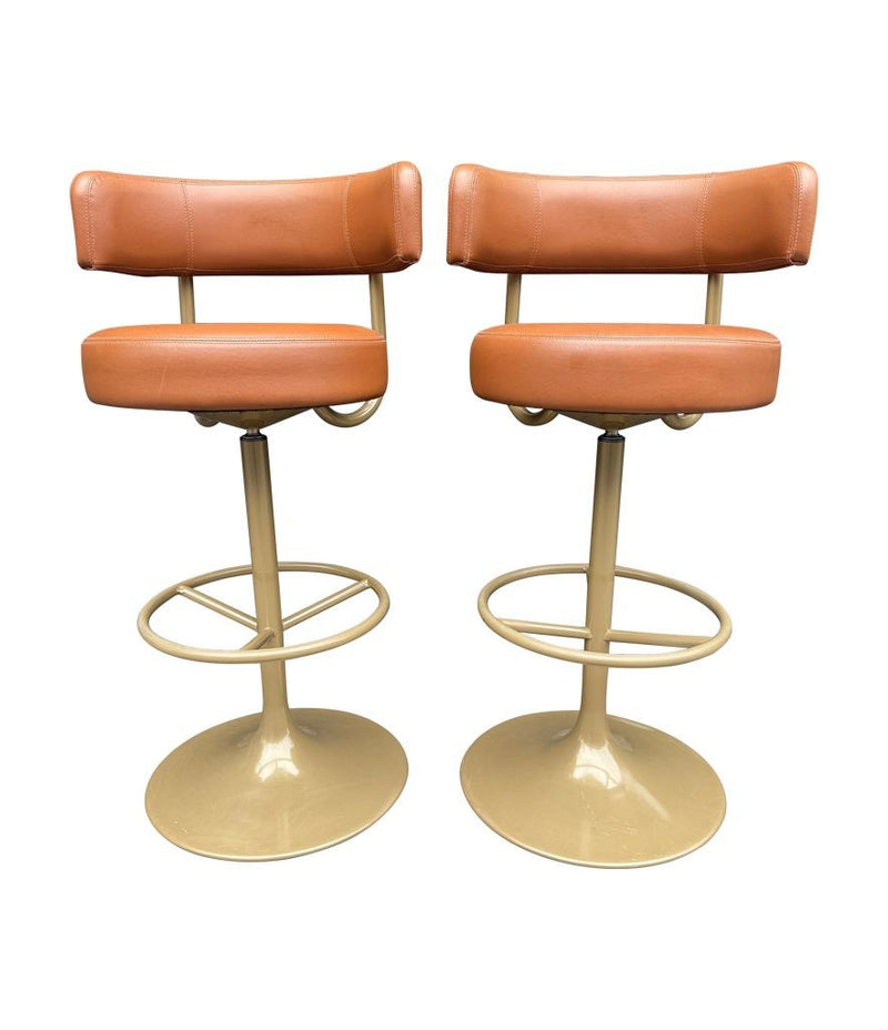 A set of four Börje Johanson “Jupiter” bar stools in cognac faux leather