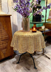 An Italian 1970s woven rattan "draped" side table with cost iron legs