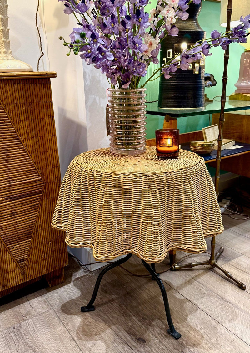An Italian 1970s woven rattan "draped" side table with cost iron legs