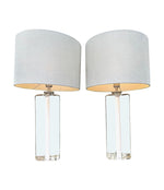 A pair of 1960s Orrefors heavy glass lamps with white glass core and nickel fittings