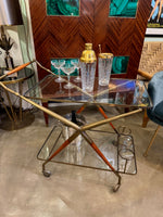 An Italian 1950s brass and lacquered wood bar trolley by Cesare Lacca