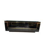 A 1970s vintage black piano lacquer sideboard by Jean Claude Mahey for Roche Bobois with brass detail