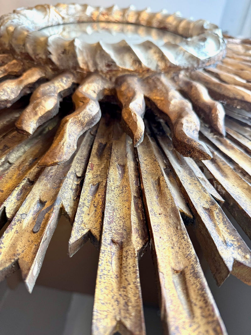 A large 1940s French carved wood gilt sunburst mirror