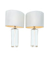 A pair of 1960s Orrefors heavy glass lamps with white glass core and nickel fittings