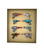 Mid century tinplate and plastic ray guns mounted in a white box frame