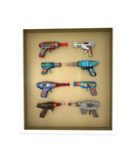 Mid century tinplate and plastic ray guns mounted in a white box frame