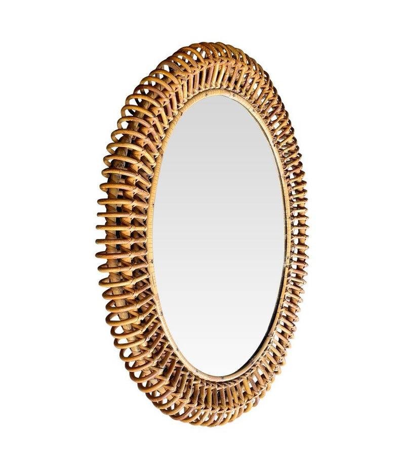 An oval Italian 1970s mirror by Franco Albini with thick hand woven bamboo frame