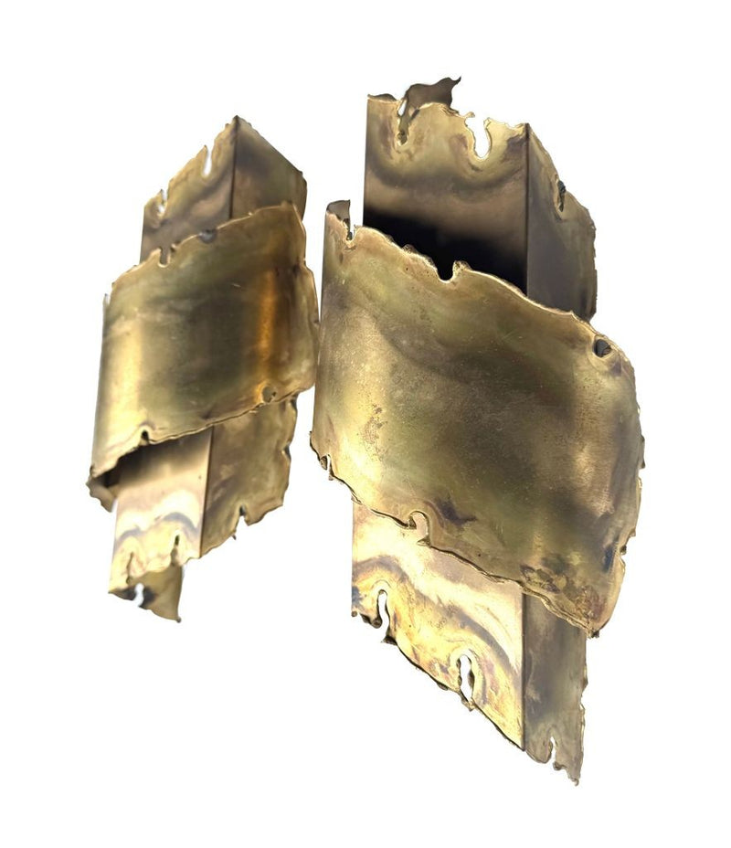 A pair of Danish 1960s torch cut brass wall sconces by Holm Sorensen.