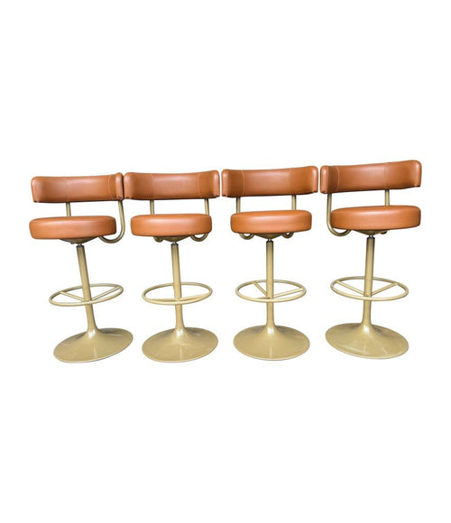 A set of four Börje Johanson “Jupiter” bar stools in cognac faux leather