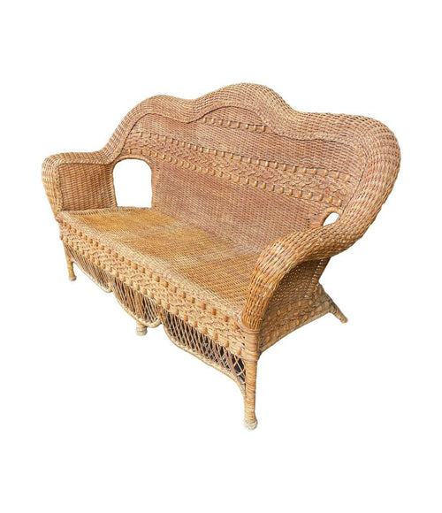 A wonderful curvaceous 1960s woven wicker and wood three seater sofa with beaded detail