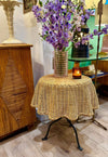 An Italian 1970s woven rattan "draped" side table with cost iron legs
