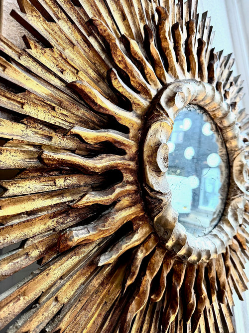 A large 1940s French carved wood gilt sunburst mirror
