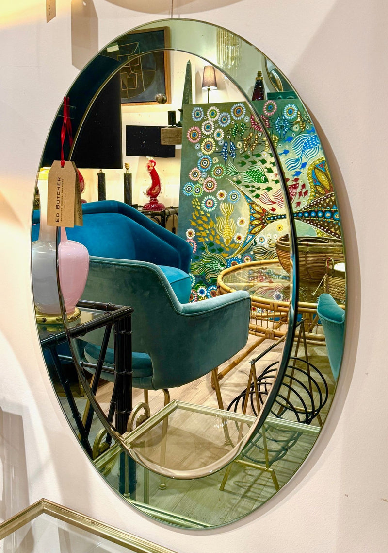 An Italian 1960s Crystal Arte oval mirror with pastel mint green mirrored frame