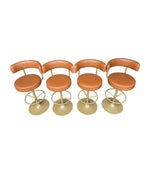 A set of four Börje Johanson “Jupiter” bar stools in cognac faux leather