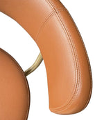 A set of four Börje Johanson “Jupiter” bar stools in cognac faux leather