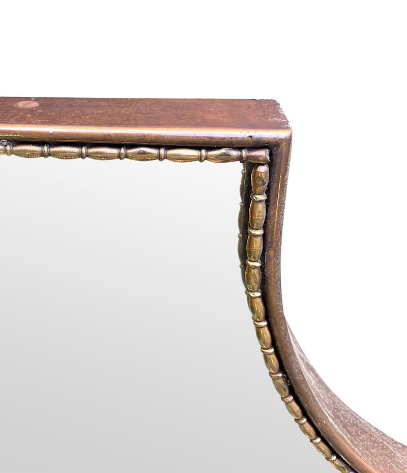 An orignal Italian 1960s brass shield mirror with beaded inner frame detail