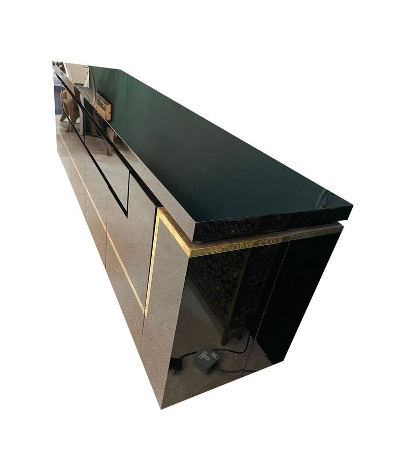 A 1970s vintage black piano lacquer sideboard by Jean Claude Mahey for Roche Bobois with brass detail