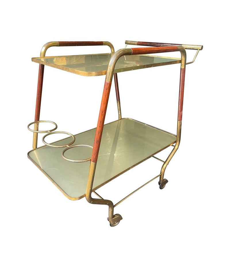 Vintage drinks trolley by Cesare Lacca, gold and lacquered wood with gold painted glass shelves, brass bottle holder and original brass castors. Italian Circa 1950s 