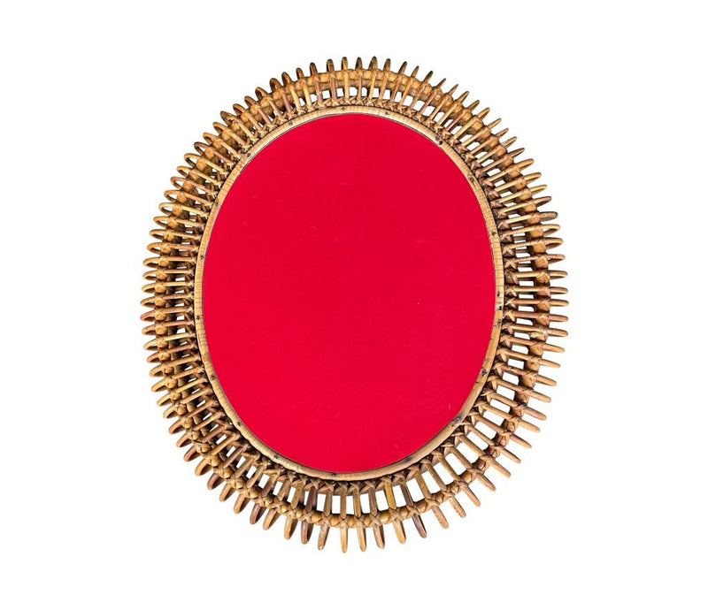 An oval Italian 1970s mirror by Franco Albini with thick hand woven bamboo frame