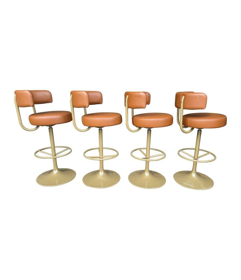 A set of four Börje Johanson “Jupiter” bar stools in cognac faux leather