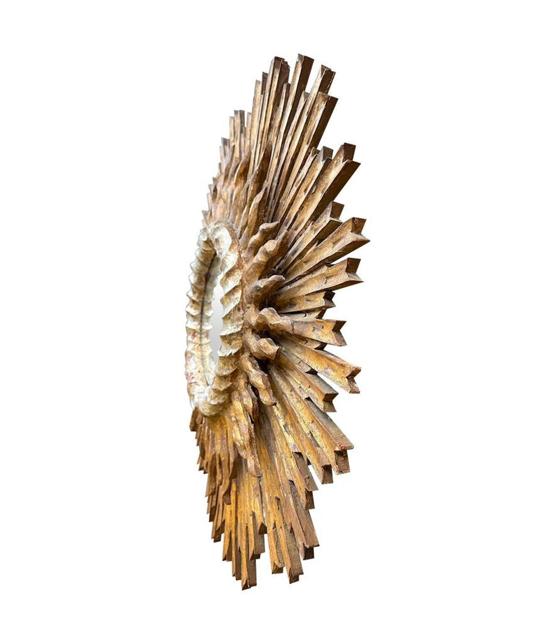 A large 1940s French carved wood gilt sunburst mirror