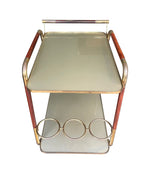 Vintage drinks trolley by Cesare Lacca, gold and lacquered wood with gold painted glass shelves, brass bottle holder and original brass castors. Italian Circa 1950s 