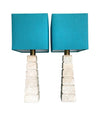 Mid Century table lamps with Travertine bases and brass fittings with blue linen shades