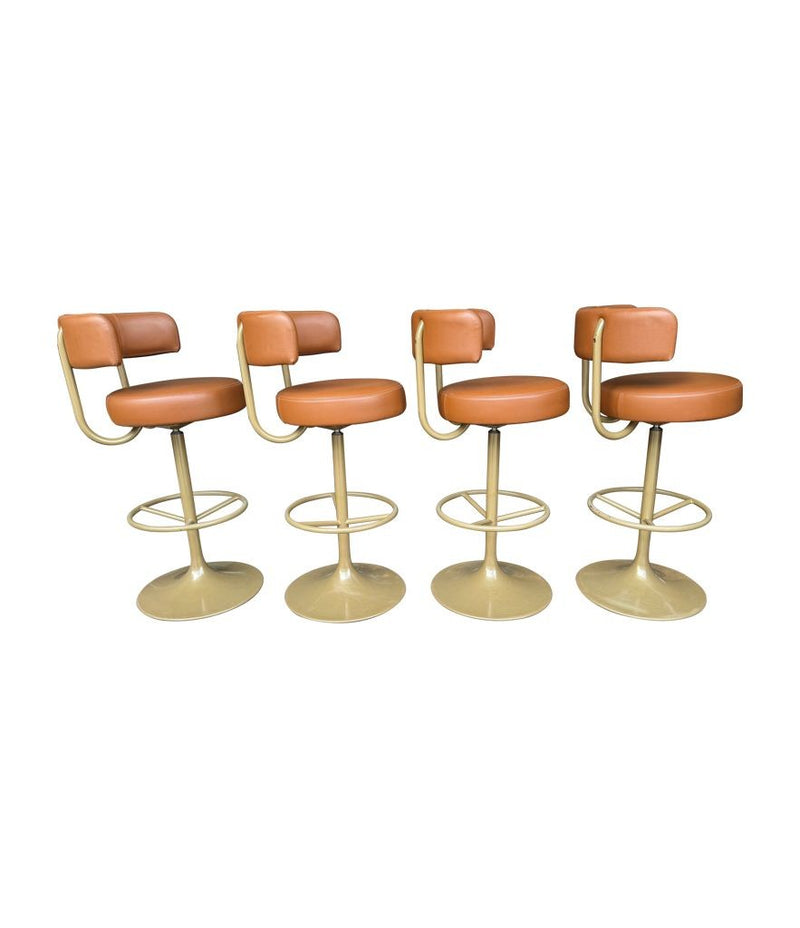 A set of four Börje Johanson “Jupiter” bar stools in cognac faux leather