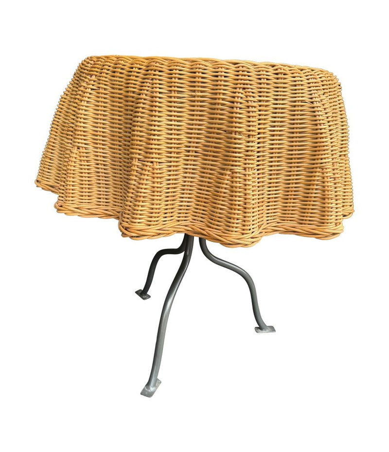 An Italian 1970s woven rattan "draped" side table with cost iron legs