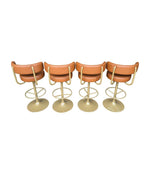 A set of four Börje Johanson “Jupiter” bar stools in cognac faux leather