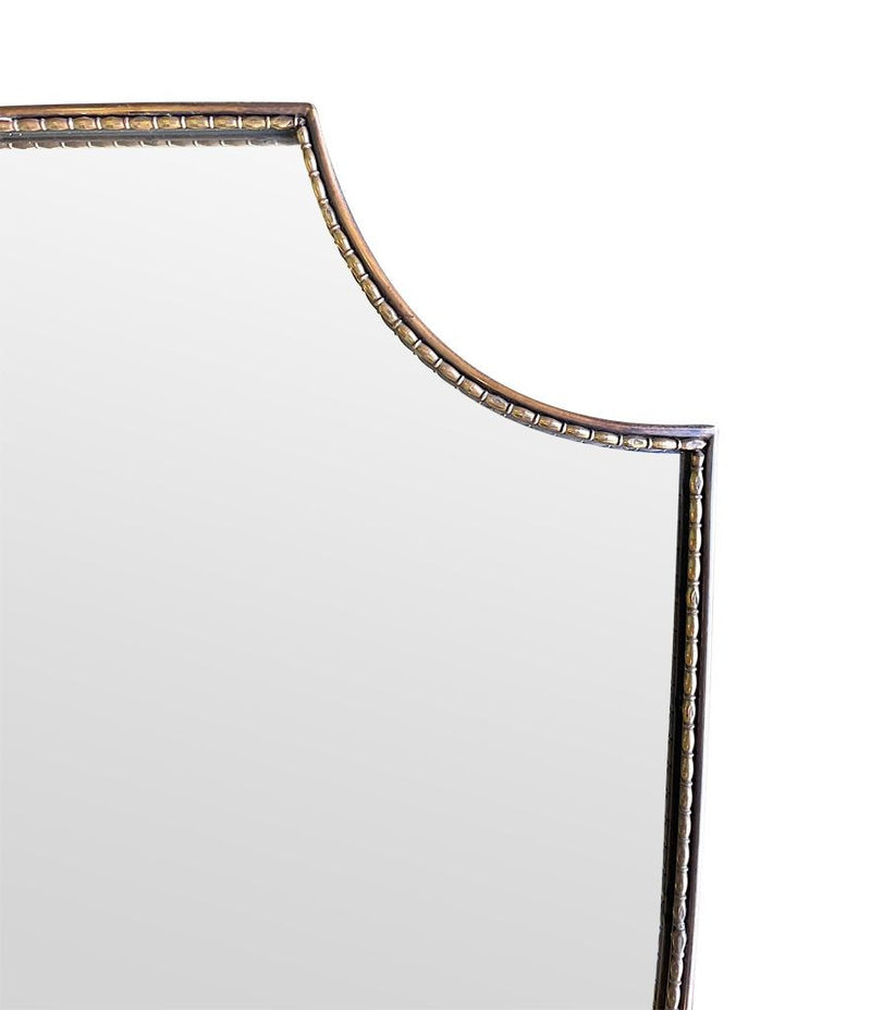 An orignal Italian 1960s brass shield mirror with beaded inner frame detail