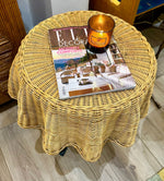 An Italian 1970s woven rattan "draped" side table with cost iron legs