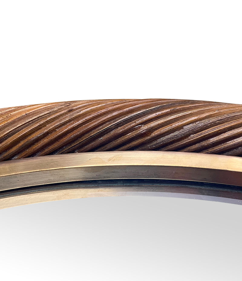 A large oval Italian 1970s twisted rattan and brass mirror in the style of Gabriella Crespi
