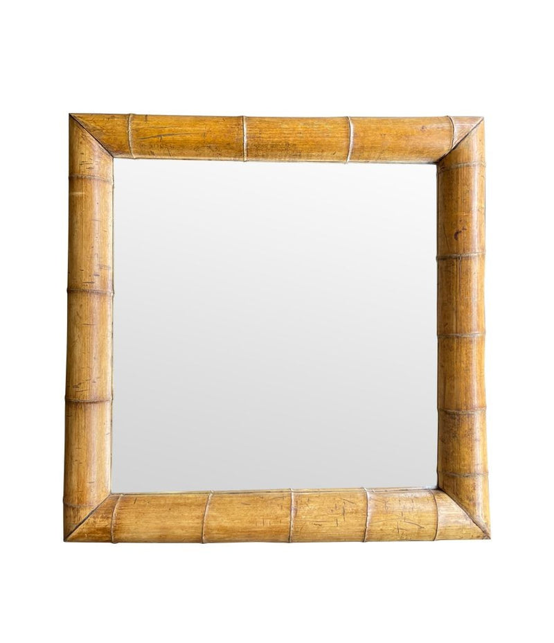 A large square mirror with a thick bamboo frame