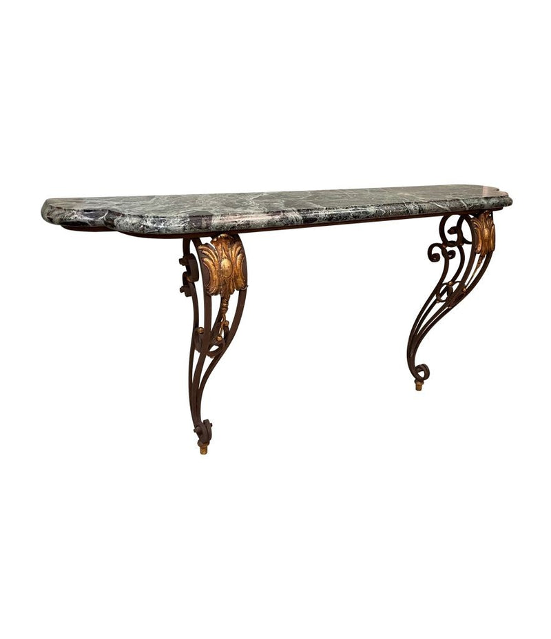 An Art Deco wrought iron gilded console table with green marble top in the style of Gilbert Poillerat