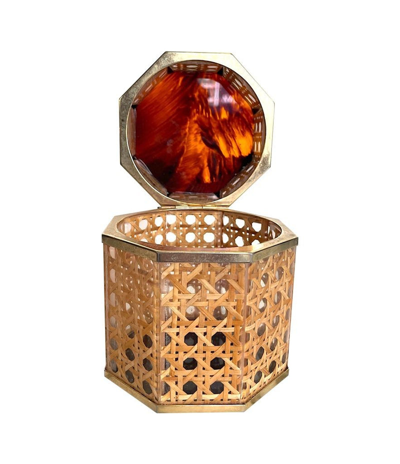 An octagonal rattan jewellery box with brass trim and faux tortoiseshell top in the style of Gabriella Crespi for Dior Home