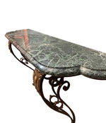 An Art Deco wrought iron gilded console table with green marble top in the style of Gilbert Poillerat