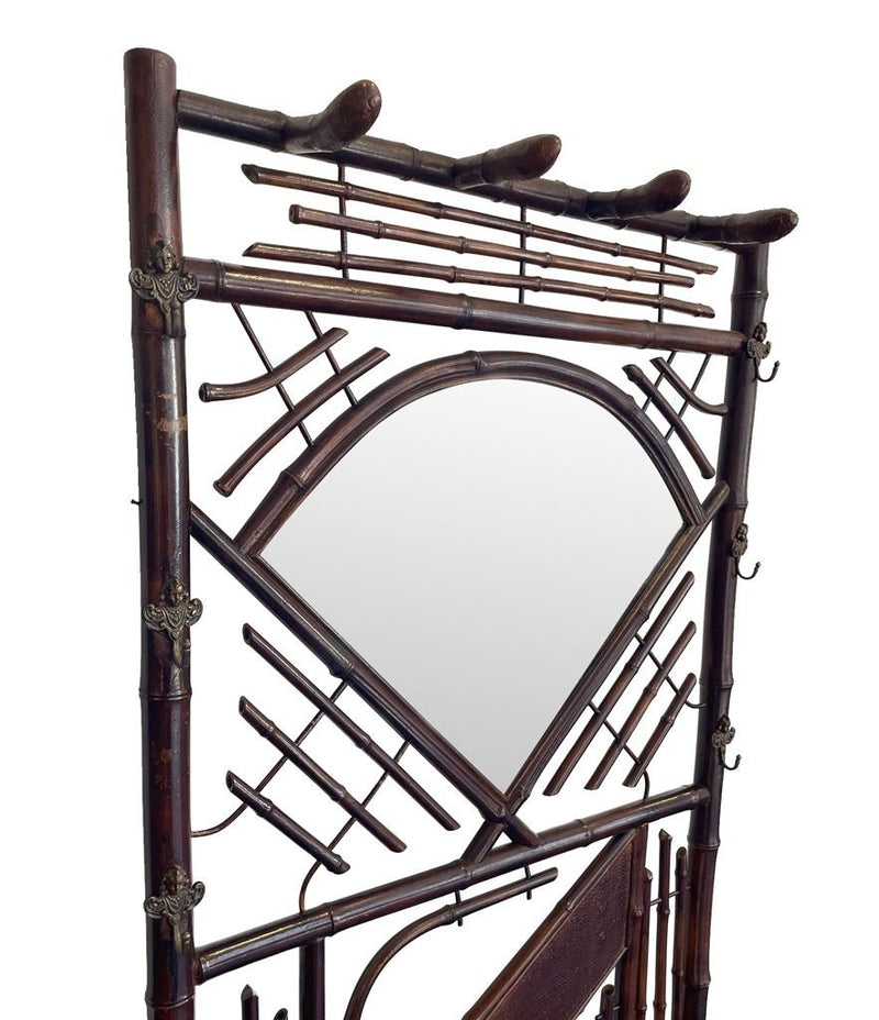 A 1920s bamboo coat and hat stand with central mirror and umbrella stand