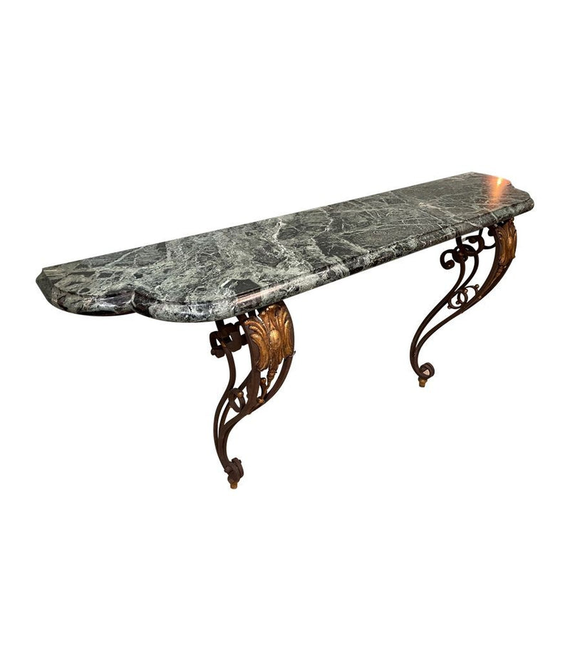 An Art Deco wrought iron gilded console table with green marble top in the style of Gilbert Poillerat