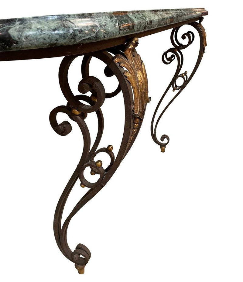 An Art Deco wrought iron gilded console table with green marble top in the style of Gilbert Poillerat